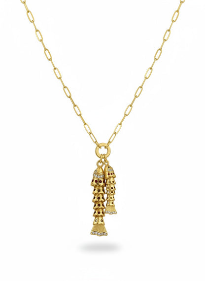 SHINY COLLECTION gold necklace with two dangling fish charms adorned with red stones and small diamonds.